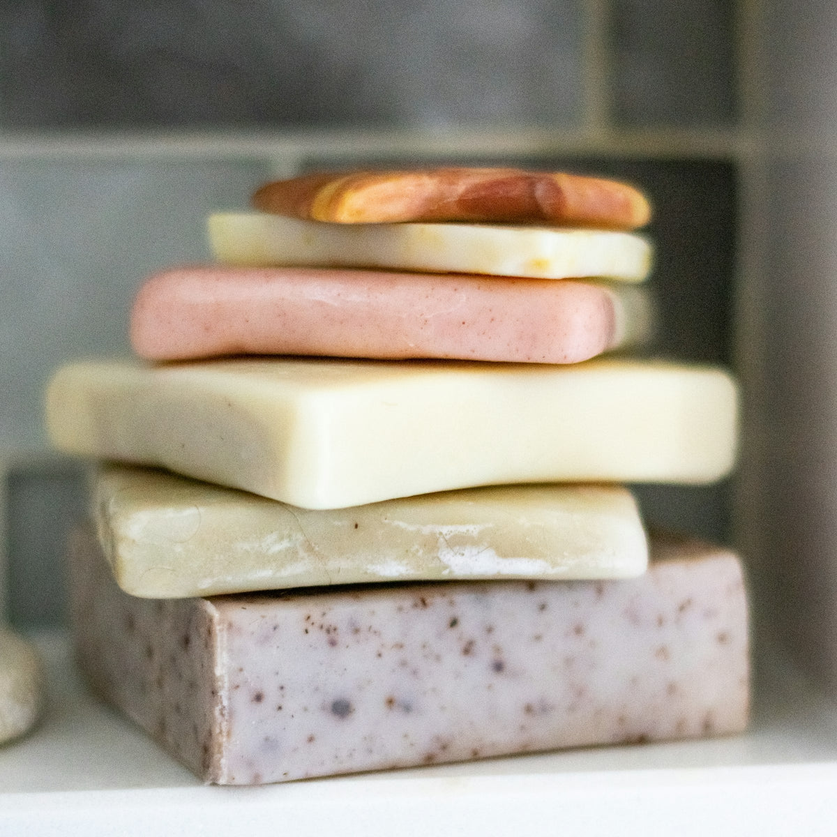 A stack of pastel handmade soap bars